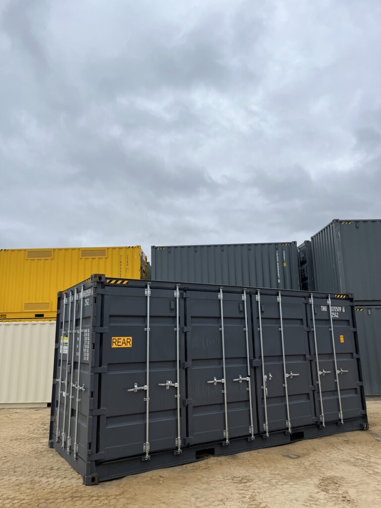 Black20’HC Side Opening Container labeled REAR, with yellow and gray containers