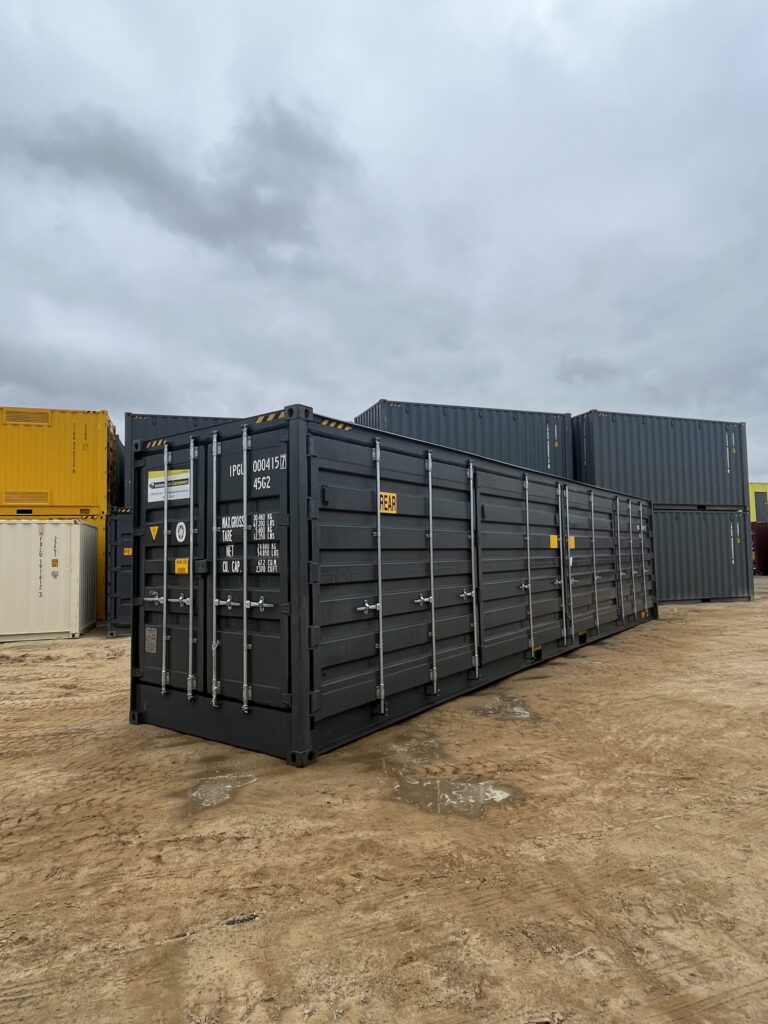 Rear view of a black 40’HC Side Opening Container on a construction site.