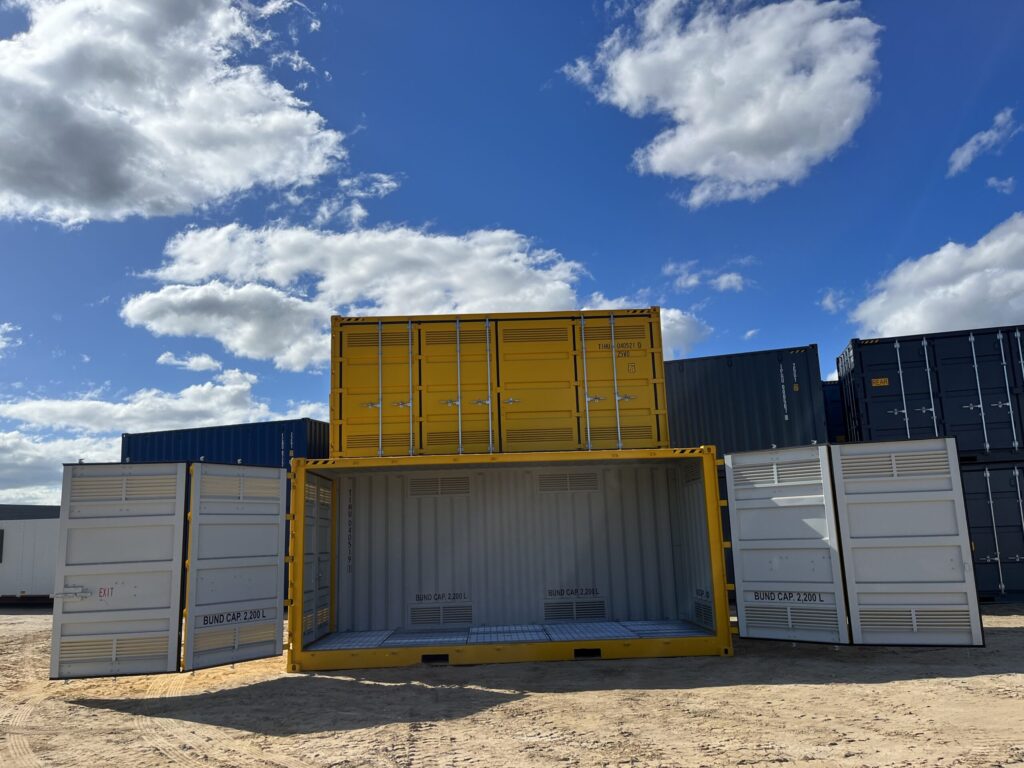 Industrial storage yard featuring stacked yellow and gray containers.