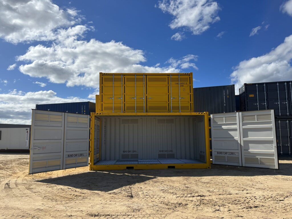 Outdoor storage facility with stacked yellow and gray shipping containers.