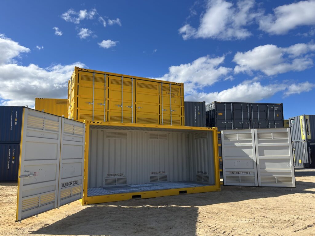 Partially open yellow container revealing interior, with other containers in the