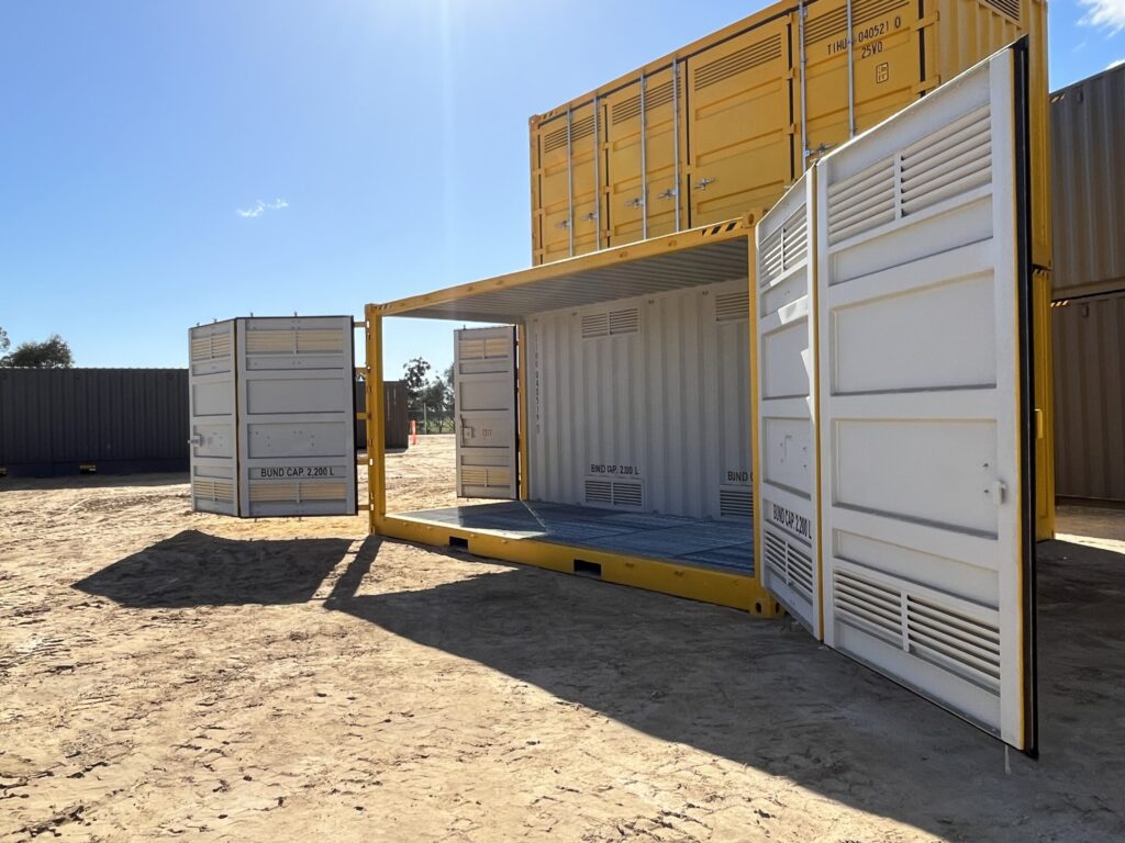 Shipping container showing interior details, bund capacity labels, and open door