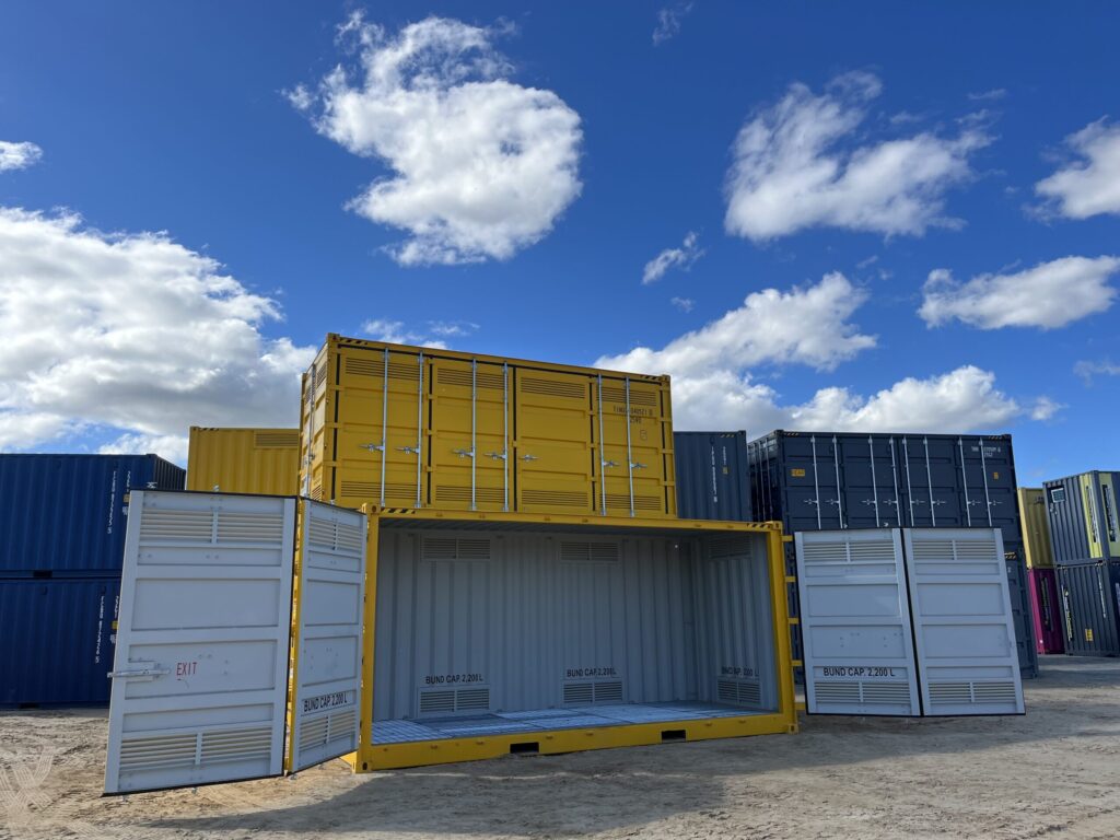 Yellow shipping container with open doors, displaying interior bund capacity mar