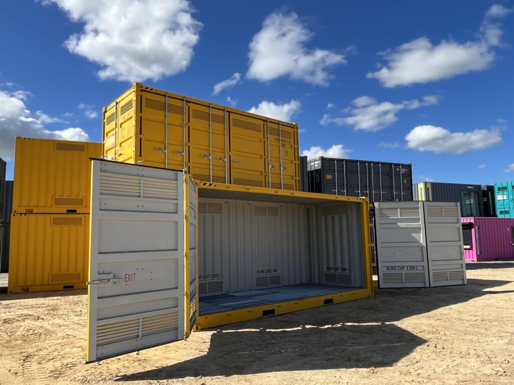 Yellow shipping container with open doors, showcasing an empty interior and bund