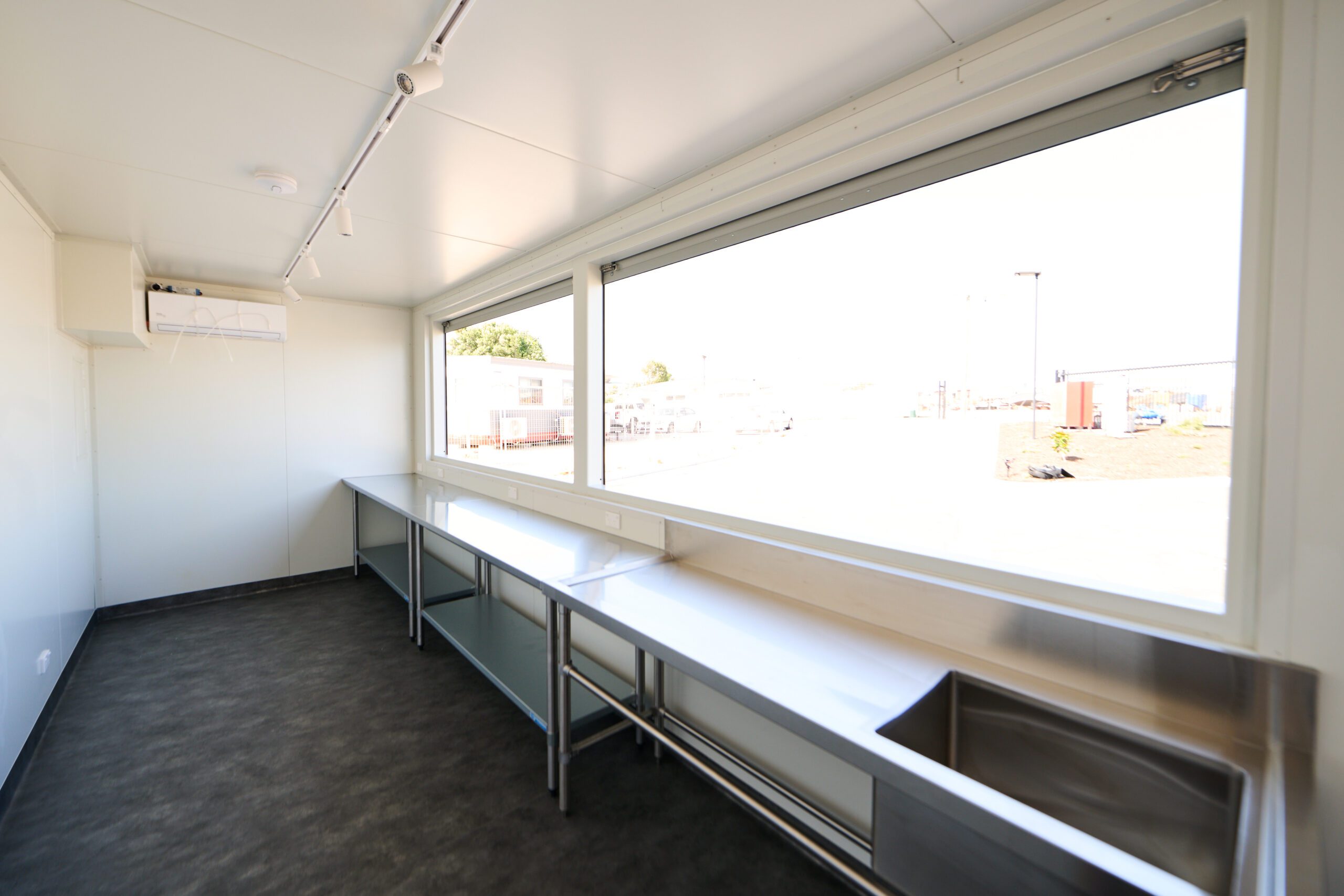 Interior of a Shipping Container Bars with stainless steel countertop and large window
