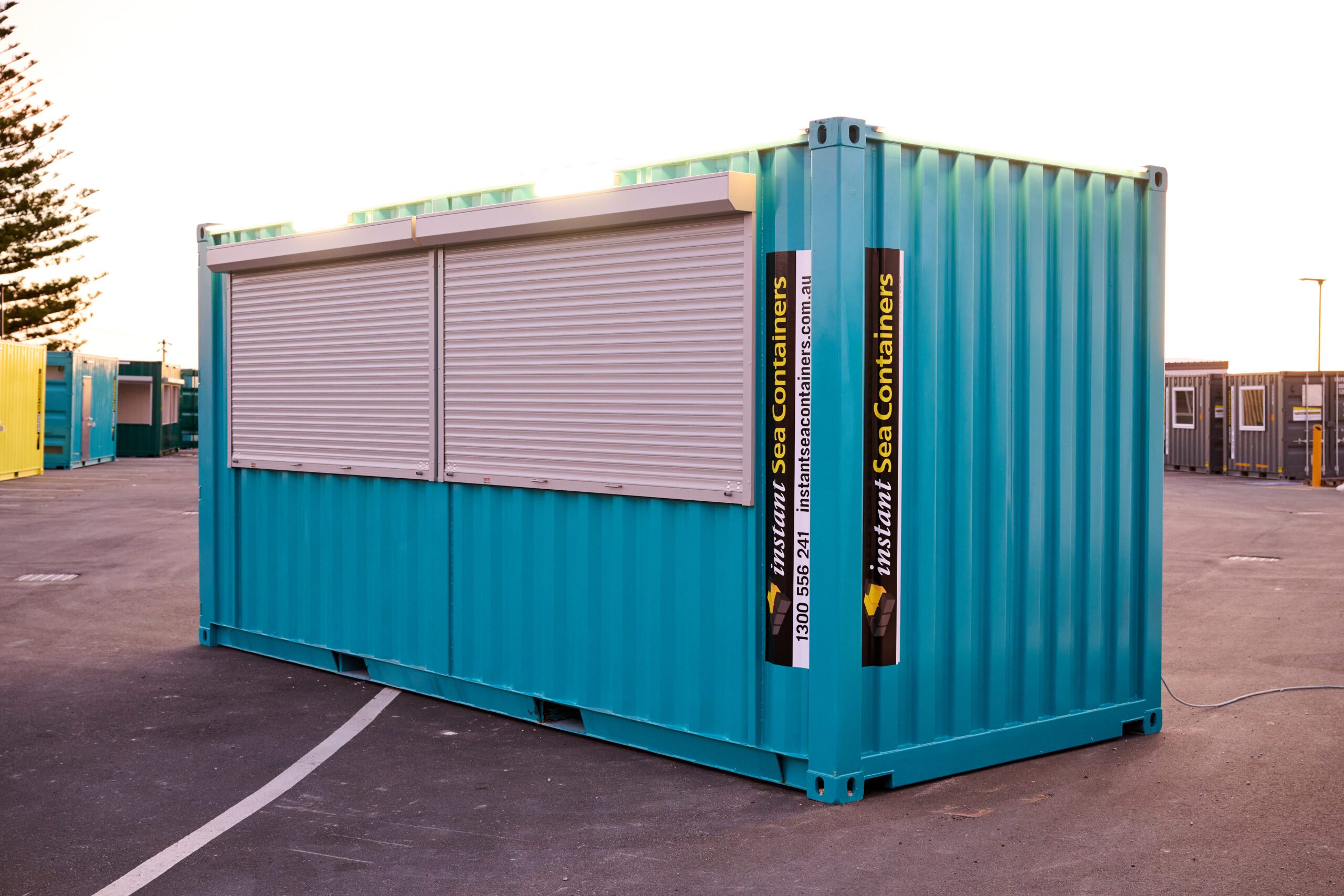 Shipping Container Bar with roll-up windows and branding signage, converted for commercial use