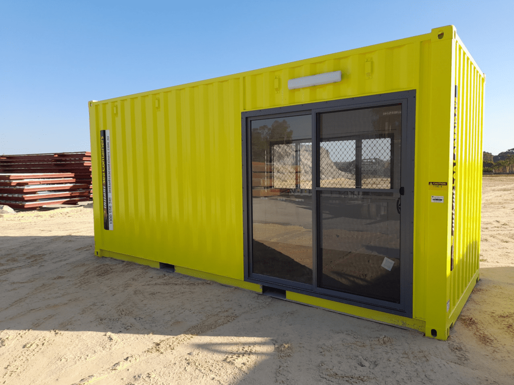 bright yellow portable office container with large windows and a door
