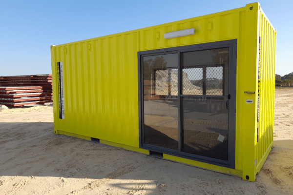 bright yellow portable office container with large windows and a door