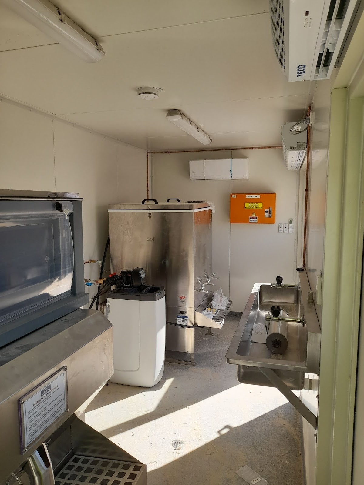 Interior of ice room container with stainless steel sink and freezer.